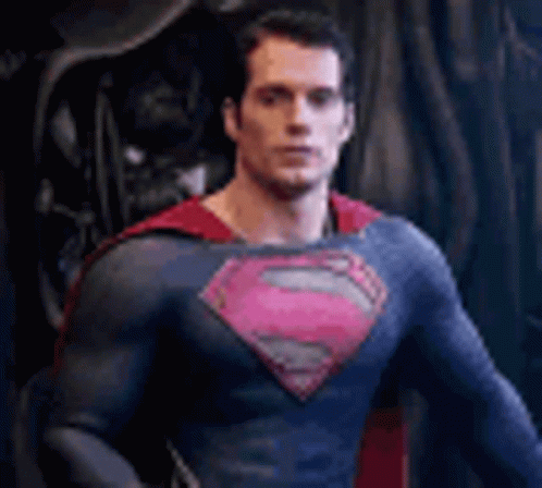 a man in superman suit is standing in front of another man