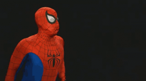 the man is standing in his spider - man costume