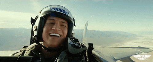 a man with a smile is laughing next to a jet
