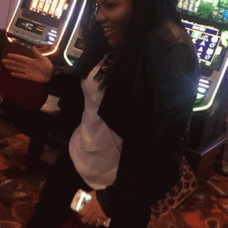 there is a young woman playing a slot machine