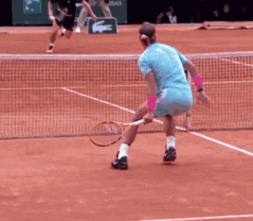 two men are playing a doubles tennis game