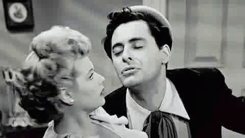 black and white image of a man singing a song to a woman