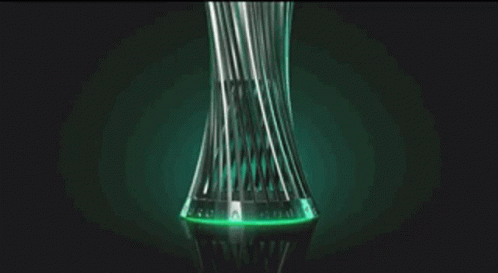 a vase with green liquid inside and black background