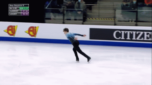 figure skater in midair skating around an ice rink