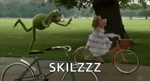 a person riding a bike next to a green insect