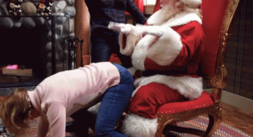 a person in a santa suit hing a blue chair