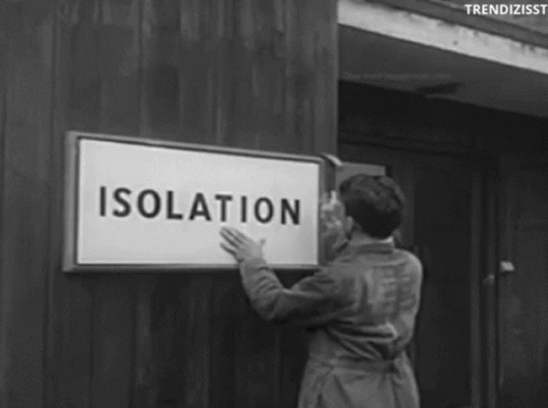 vintage woman hanging a isolation sign on a wall