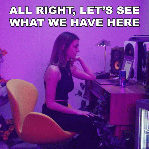 a girl is sitting at her computer desk