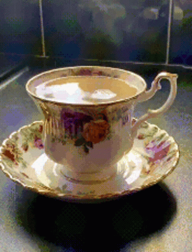 a cup and saucer that has flowers on it