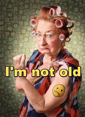 an older woman is wearing hair curls in the face and holding her hand up