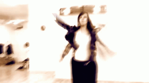 a blurry image of a woman dancing in a room
