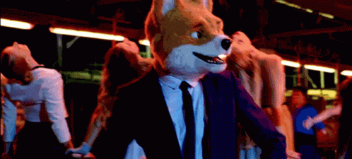 a man in a suit and mask walking with a stuffed animal