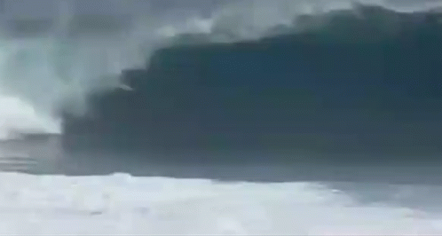 a man is surfing a big wave in the ocean