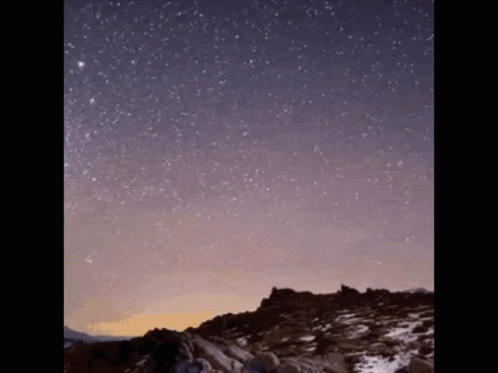 a large mountain covered in snow under the stars