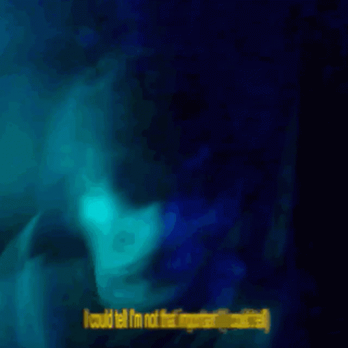 blurry picture of a woman with a blue glow around her face