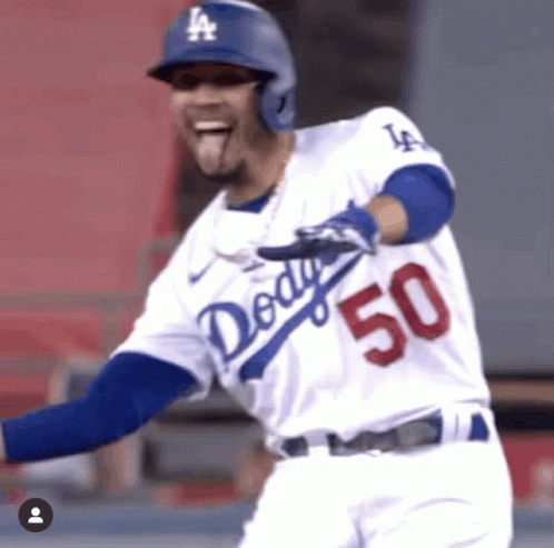 a baseball player is running to base with a big smile on his face
