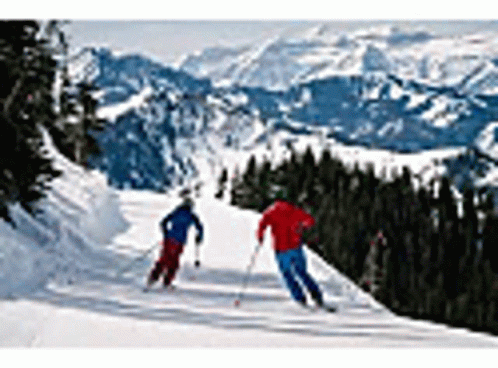 two people skiing on a mountain with some snow