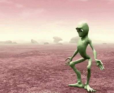 an animated alien walks through the desert with no one