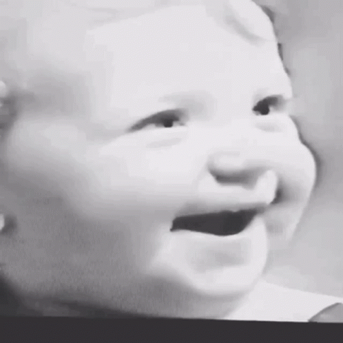a baby that is crying and sticking it's tongue out