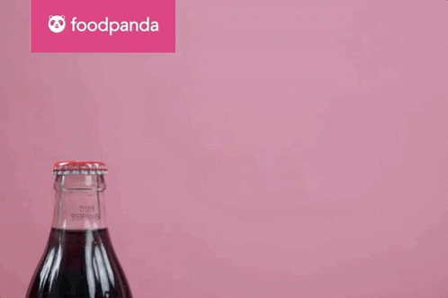 an image of soda bottle with liquid coming out of it