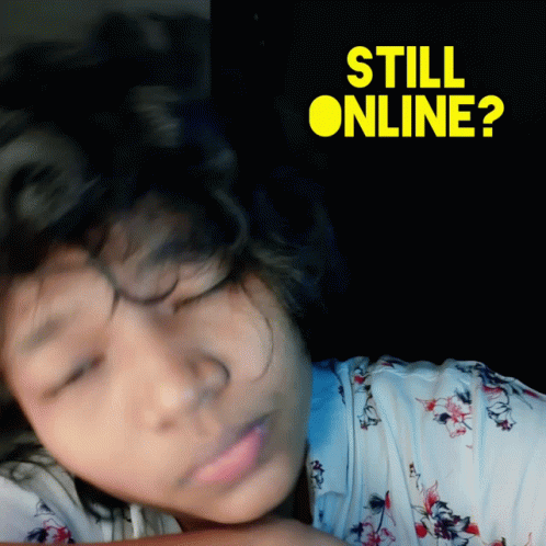 an asian child laying on a bed with the words still online written above it
