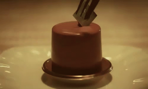 a cake is being flipped by a knife
