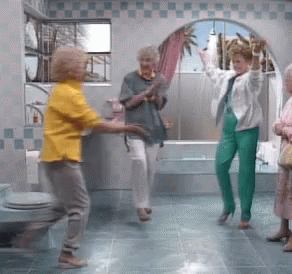 two elderly women are dancing with one another in the bathroom