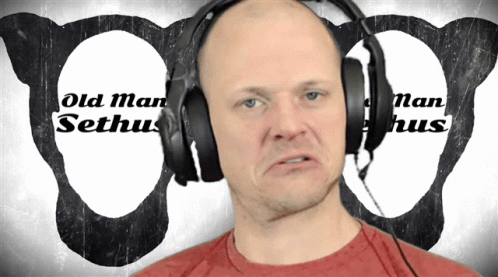 the man wearing headphones is frowning while talking