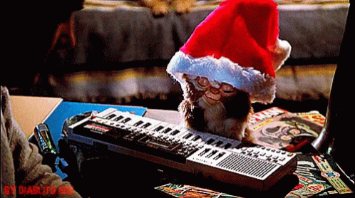 a picture of a cat wearing a blue hat next to a keyboard