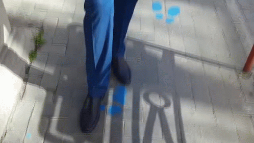 the shadows on the sidewalk show people walking up and down