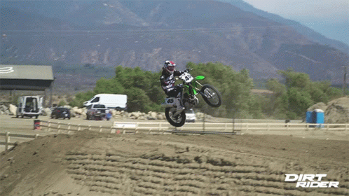 a man jumping on a dirt bike in the air