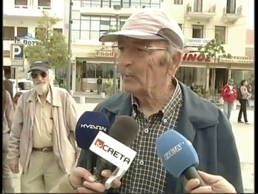 an old man talking to a news reporter