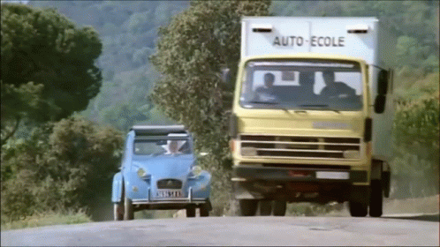 a car and a truck travel down a road