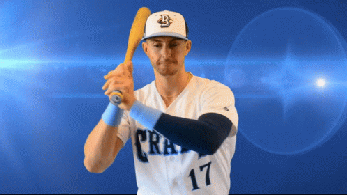 a baseball player in a uniform poses with a bat