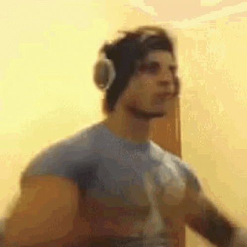 a man in headphones is walking in a room