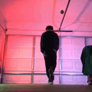 two people walking down a hallway at night