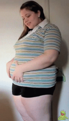 a pregnant woman posing with her hands on her hip