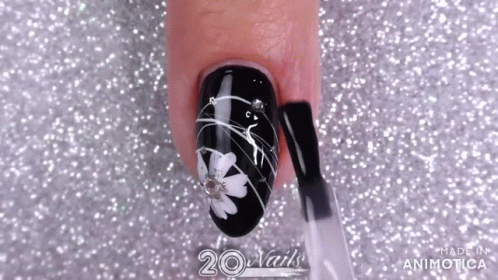 the top of the nail is very decorated with a cat