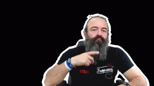 a bearded man points while standing