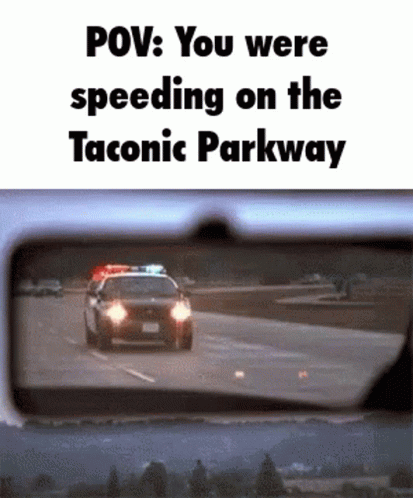 a reflection of a police car in a rear view mirror