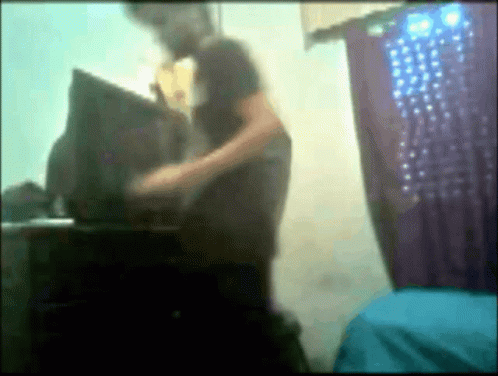a blurry pograph of someone standing next to a computer