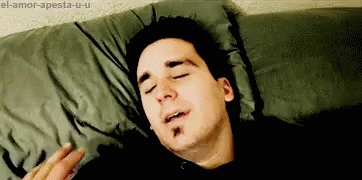 a man laying on his side with his eyes closed