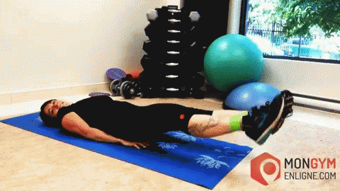 a person laying on a mat and using a exercise machine