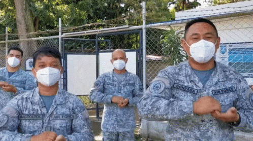 two military officers with blue face paint and their protective masks