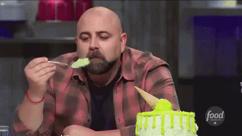 a man eating cake and looking to his left