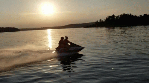 two people on a motor boat in a lake
