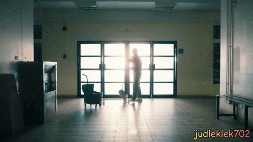 a man and woman standing in an empty building
