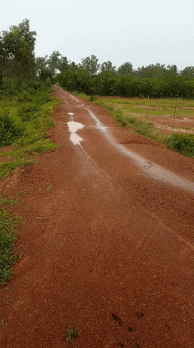 a road with a blue patch of dirt