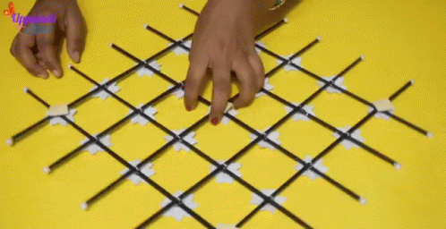 a person using a manicure on their nails on a large diamond - shaped rug