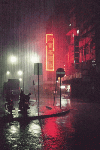 a wet street with lights shining in the dark